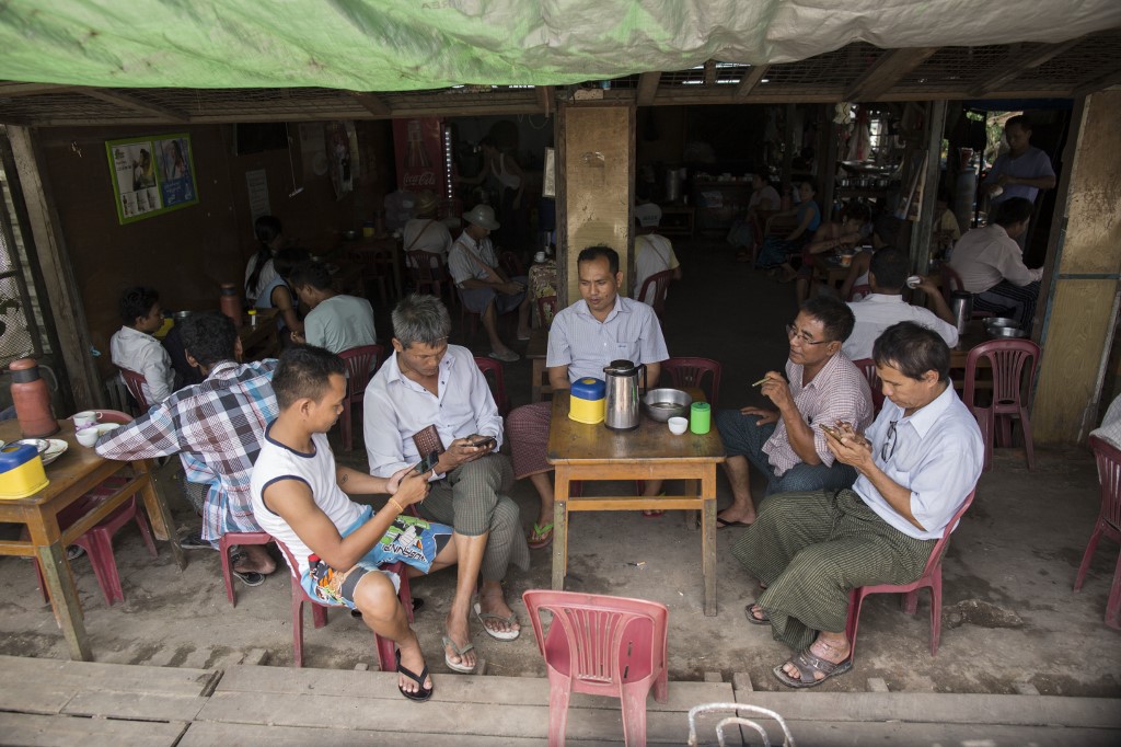 Men hangout to chat and browse Facebook at a Yangon teashop. (Sai Aung / AFP)