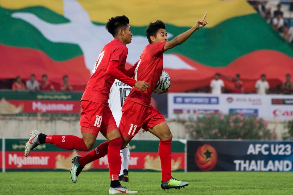 Myanmar's Hein Htet Aung (R) celebrates scoring during the Tokyo 2020 Olympic Games men's Asian qualifier football match between Myanmar and East Timor in Yangon on March 22, 2019.  (Sai Aung Main / AFP)