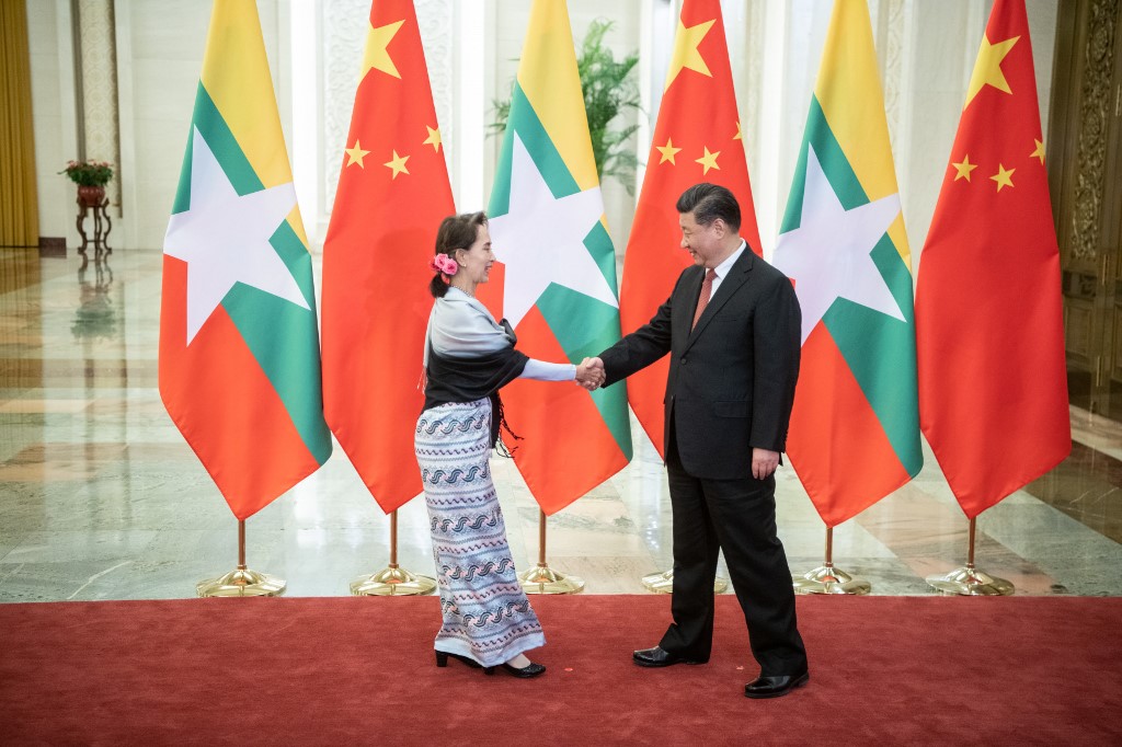 Chinese President Xi Jinping (R) shakes hands with Myanmar State Counsellor Aung San Suu Kyi at the Great Hall of the People in Beijing on April 24, 2019. (Fred Dufour / Pool / AFP)