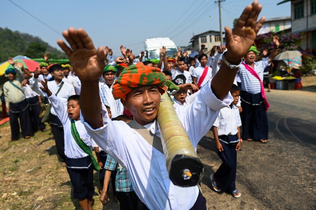 Pa'O ethnic people dance as they bring a homemade rocket to launch during a festival in Nantar, Shan state. (Ye Aung Thu / AFP)