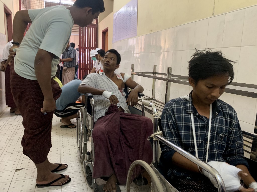 Injured people from Kyauk Tan village in Rathedaung township wait in a hospital in Rakhine state's capital Sittwe in western Myanmar on May 2, 2019, after the army opened fire on a group of ethnic Rakhine detainees at a school in the village. (STR / AFP)