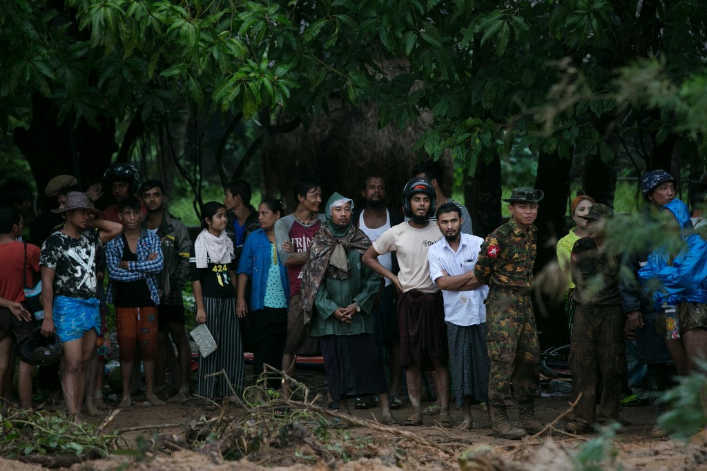  People wait to locate relatives still missing after a landslide in Paung township, Mon state on August 10, 2019. (Sai Aung Main / AFP)