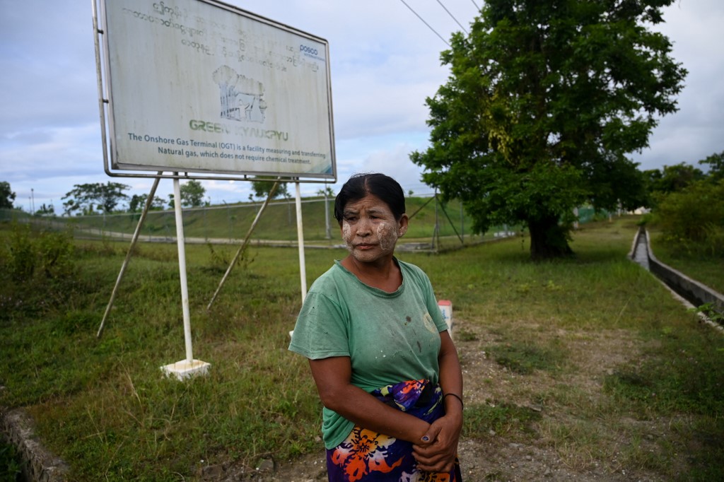 This photo taken on October 1, 2019 shows Myanmar resident Nu Aye Thar, standing outside the Posco International, formerly Posco Daewoo corporation, a South Korean onshore gas terminal facility in Kyaukphyu, Rakhine State. (Ye Aung Thu / AFP)