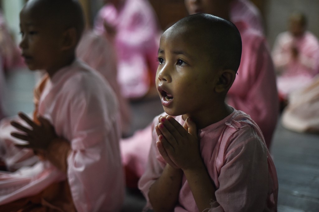 Buddhist nuns pray in the Mingalar Thaikti nunnery in Yangon. (Ye Aung Thu / AFP)