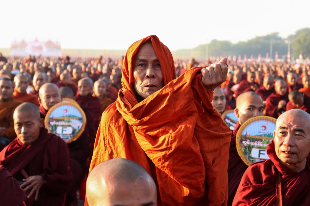 Monks line up for alms during the alms-giving ceremony to 30,000 monks organize by the region government of Mandalay affiliated with Dhammakaya Foundation at Chanmyathazi Airport. (Kyaw Zay Win)