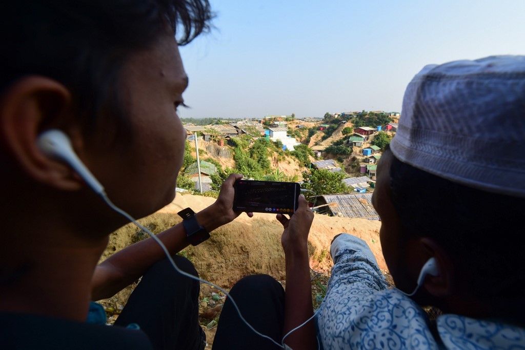 Rohingya refugees watch a livefeed of Myanmar's State Counsellor Aung San Suu Kyi's appearance at the UN's International Court of Justice in The Hague. (Munir Uz Zaman / AFP)