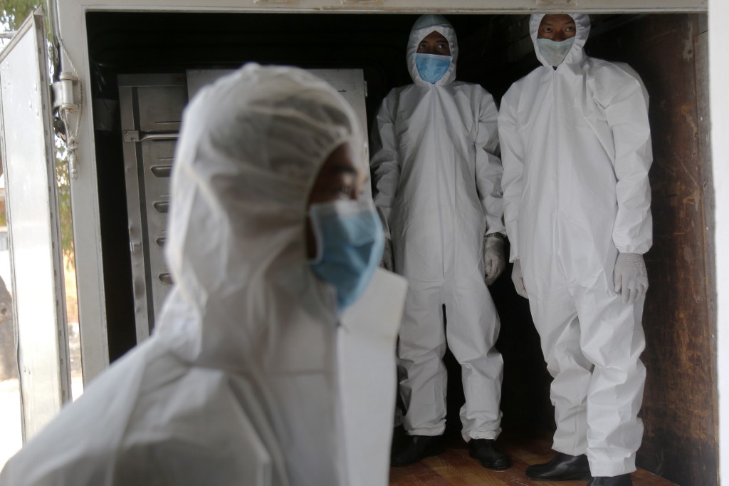 Myanmar military personnel wearing protective clothing prepare food for people confined at a community quarantine centre as a preventive measure against the spread of COVID-19 coronavirus, inside a military camp in Yangon on April 9, 2020. (Sai Aung Main / AFP)