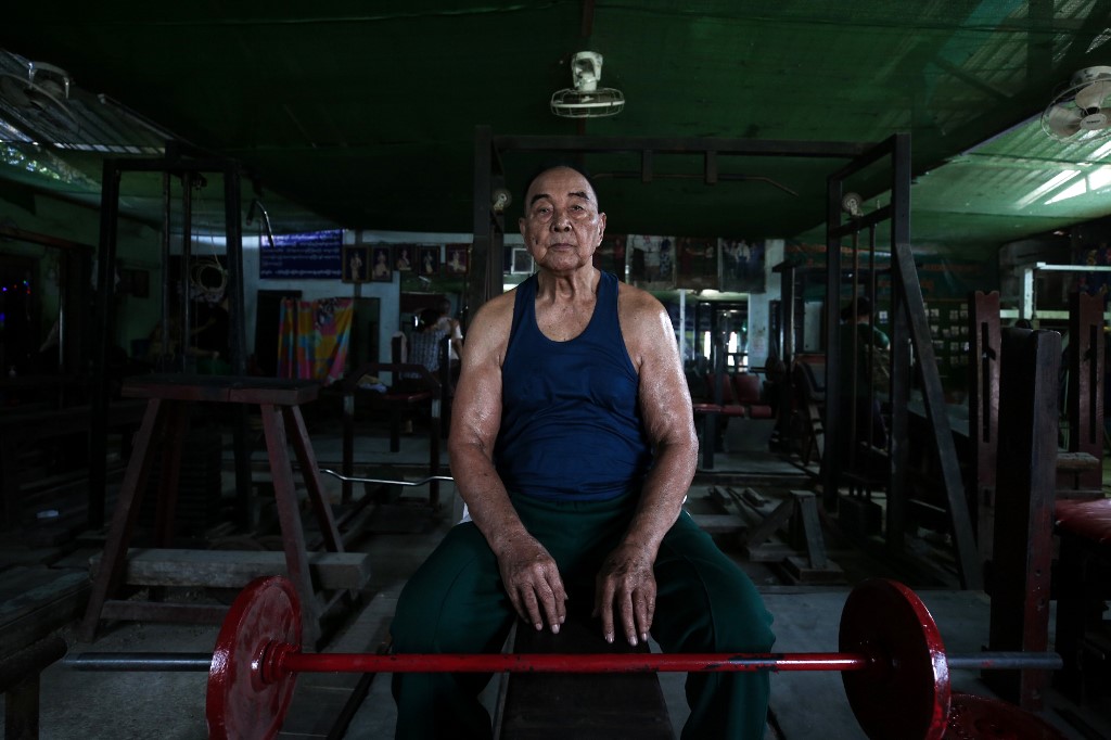 91-year-old bodybuilder Sein Maung poses for a photo as he works out with weights at his gym, which has since been closed due to fears about the spread of the COVID-19 novel coronavirus in Yangon. (Sai Aung Main)