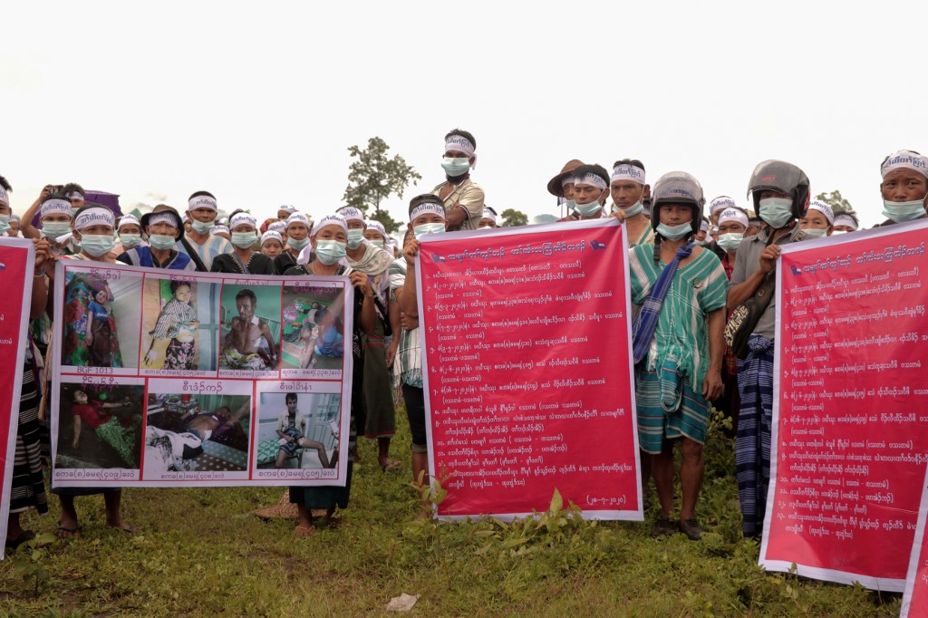 Karen ethnic people hold posters and shout slogans during a protest against Myanmar Army for the allegedly arbitrary killings, raping, shelling and for the removal of the army camps, at Hpapun township in Karen state on July 28, 2020. (STR / AFP)