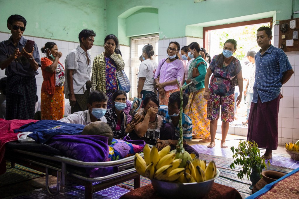 Relatives and family members look at the body of Khaing Zaw Tun, who had been held at a juvenile centre, at the Mandalay general hospital. (AFP)