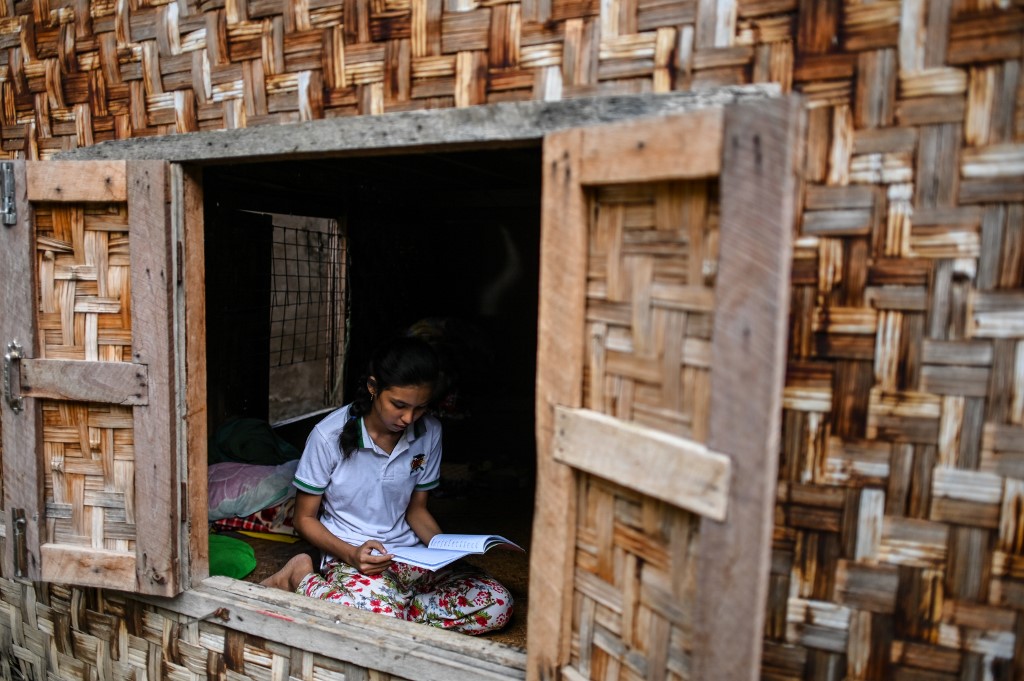 This photo taken on June 20, 2020 shows 18-year-old Muslim May Thandar Maung, who says she hasn't been able to get an ID card because of her religion and hence unable to vote in the upcoming election, studying Arabic and religion in her home in Meiktila. (Ye Aung Thu / AFP)