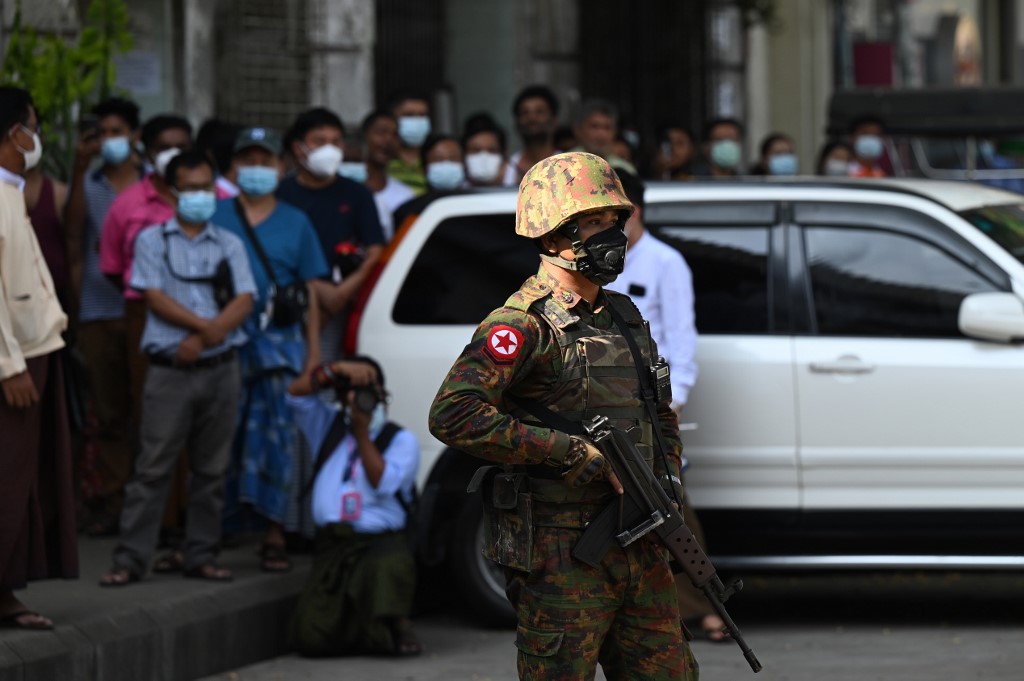 A soldier stands guard as troops arrive at a Hindu temple in Yangon on February 2, 2021, as Myanmar's generals appeared in firm control a day after a surgical coup that saw democracy heroine Suu Kyi detained. (STR / AFP)