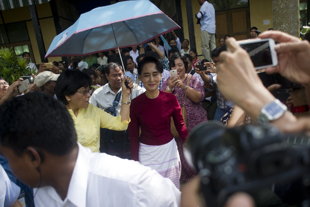 In this file photo taken on November 8, 2015, Myanmar opposition leader and head of the National League for Democracy (NLD) Aung San Suu Kyi (C) visits a polling station in Kawhmu township, Yangon. (AFP)