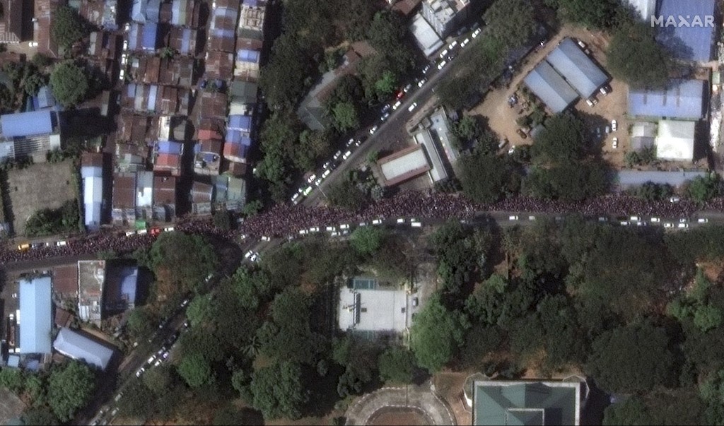 This handout satellite image released by Maxar Technologies shows a close-up of protesters along Kyun Taw Road, near Myanmar Radio and TV center in Yangon on February 8, 2021.