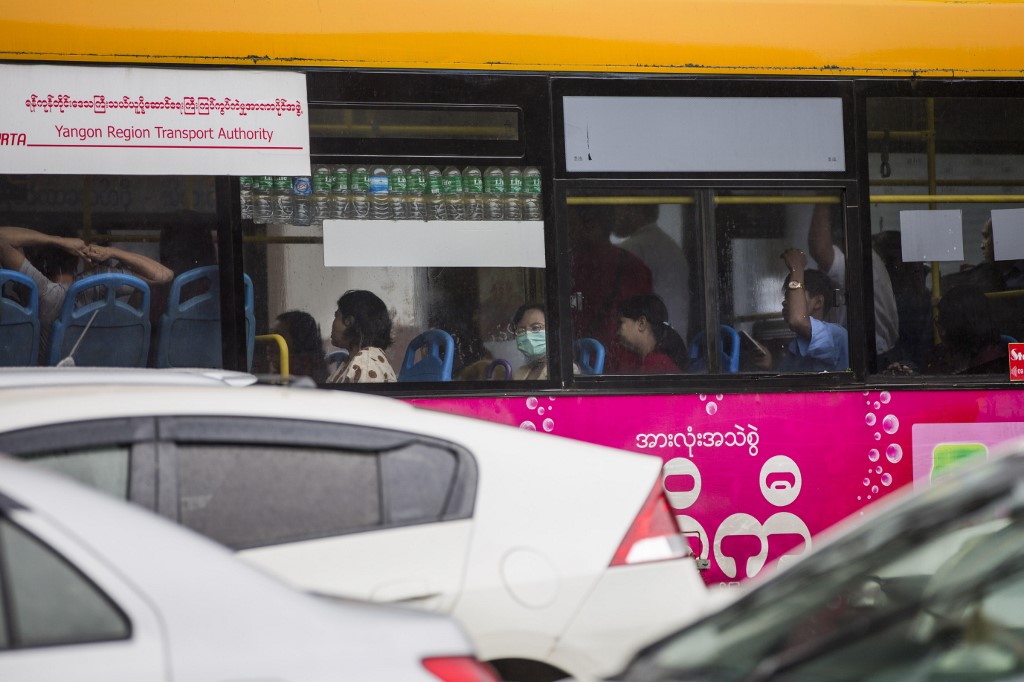 Commuters taking a bus in Yangon in July, 2017. (Aung Kyaw Htet / AFP)