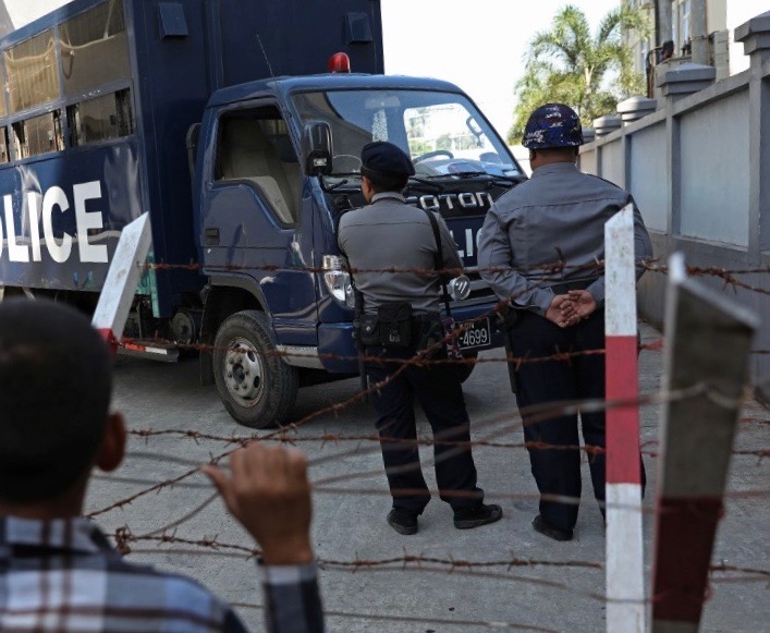 Quick and agile: Myanmar police stand near a police van outside court. (Myo Min Soe / AFP)