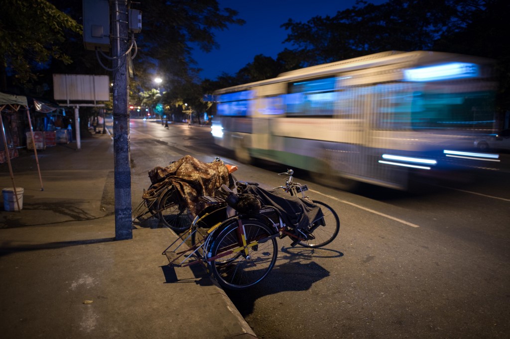 An early morning bus rushes by in Yangon. (Roberto Schmidt / AFP)