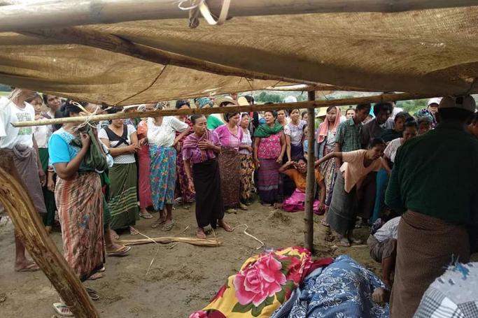  Villagers watch as bodies are recovered from the Irrawaddy River in Magway following the clashes. (Magway Region Fire Department)