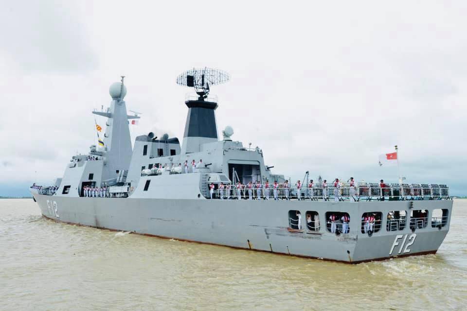 Naval officers wave from a warship as they leave Yangon on August 26. (Facebook / Myanmar navy)