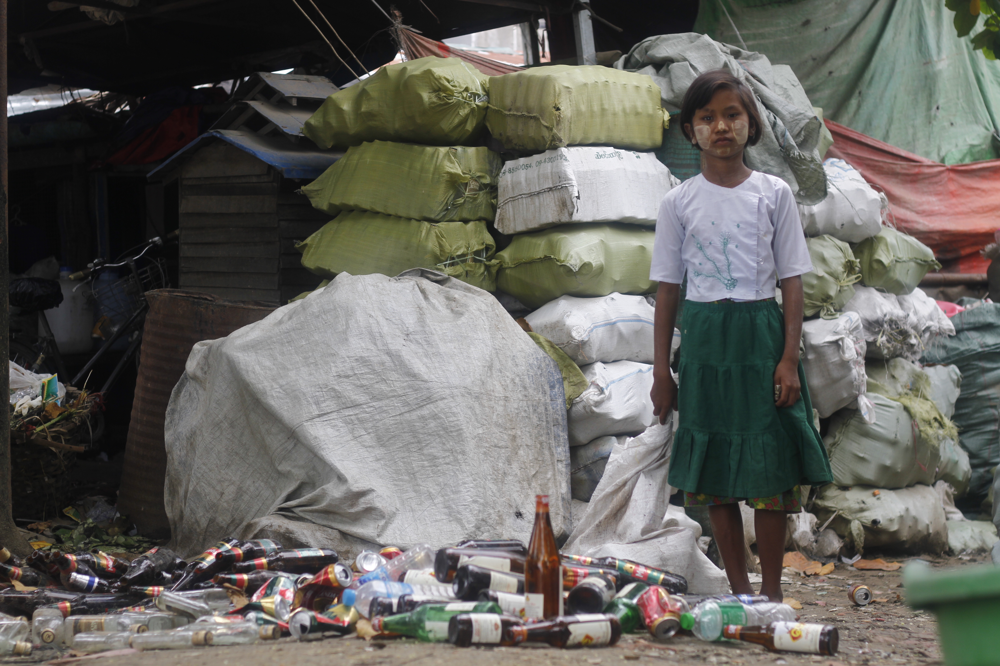 Ei Ei Thein, 13, collects recyclable bottles from rubbish tips to support her family. (Lorcan Lovett / Southeast Asia Globe)