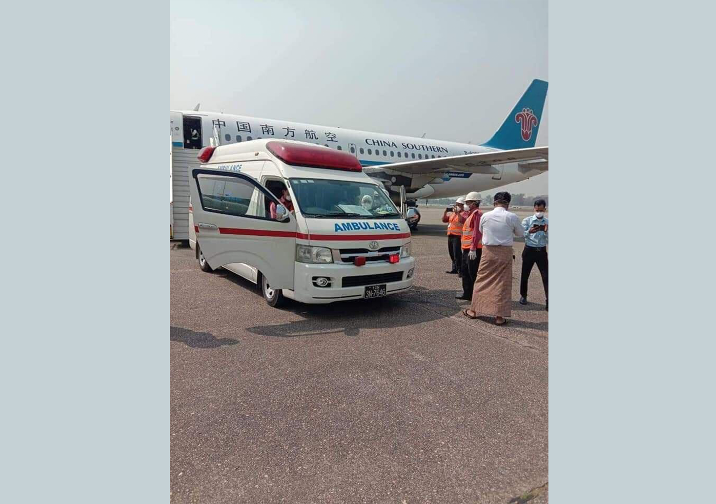 An ambulance collects a patient with the first suspected case of coronavirus in Myanmar from a runway at Yangon airport. (Facebook)