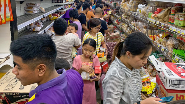 Shoppers stock up on supplies at City Mart after hearing rumours related to the coronavirus outbreak. (AFP)