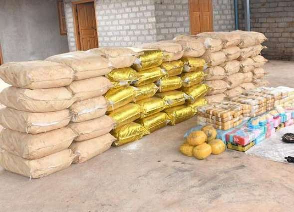 Bags of crystal methamphetamine and yaba pills alongside weapons seized by the Myanmar police photographed near Loikan village, Shan state. (Myanmar Police/UNODC)