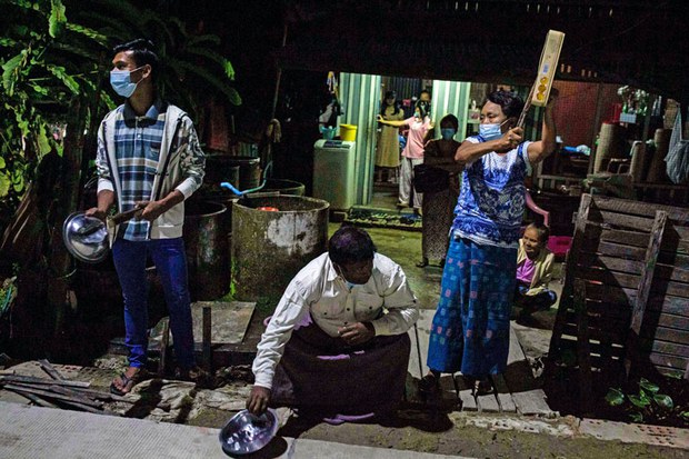 Myanmar citizens in Yangon clatter tins and pans to make noise to protest a military coup that toppled the civilian-led government. (AFP)