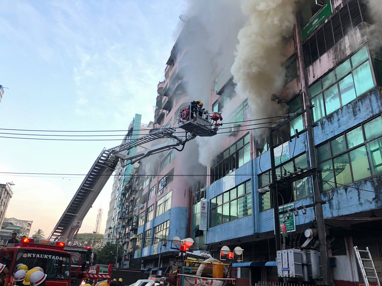 Smoke billows from an apartment block and market in Yangon's Lanmadaw township. (Myanmar Fire Services Department / Facebook)