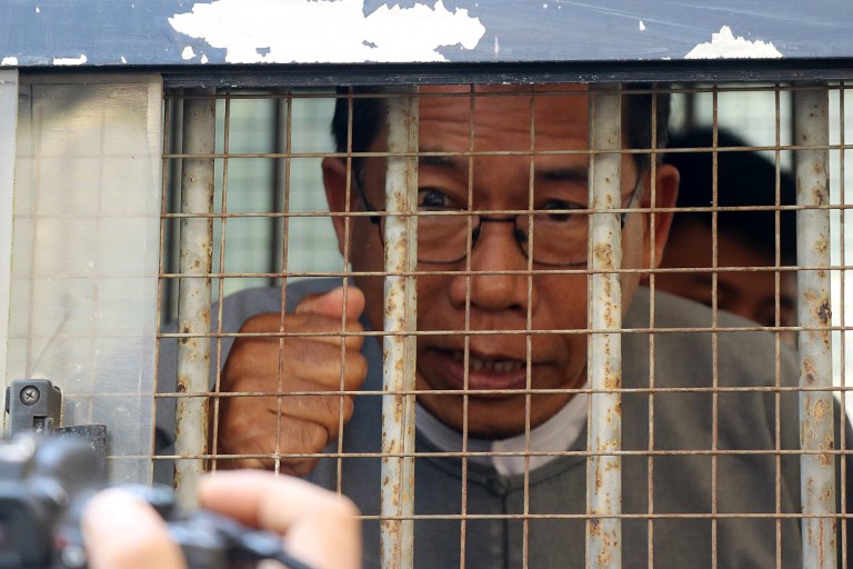 Aye Maung, Ann Township MP and former Arakan National Party leader, speaks to the media as he is escorted out of court after his hearing in Sittwe, Rakhine on March 19, 2019. (STR / AFP)