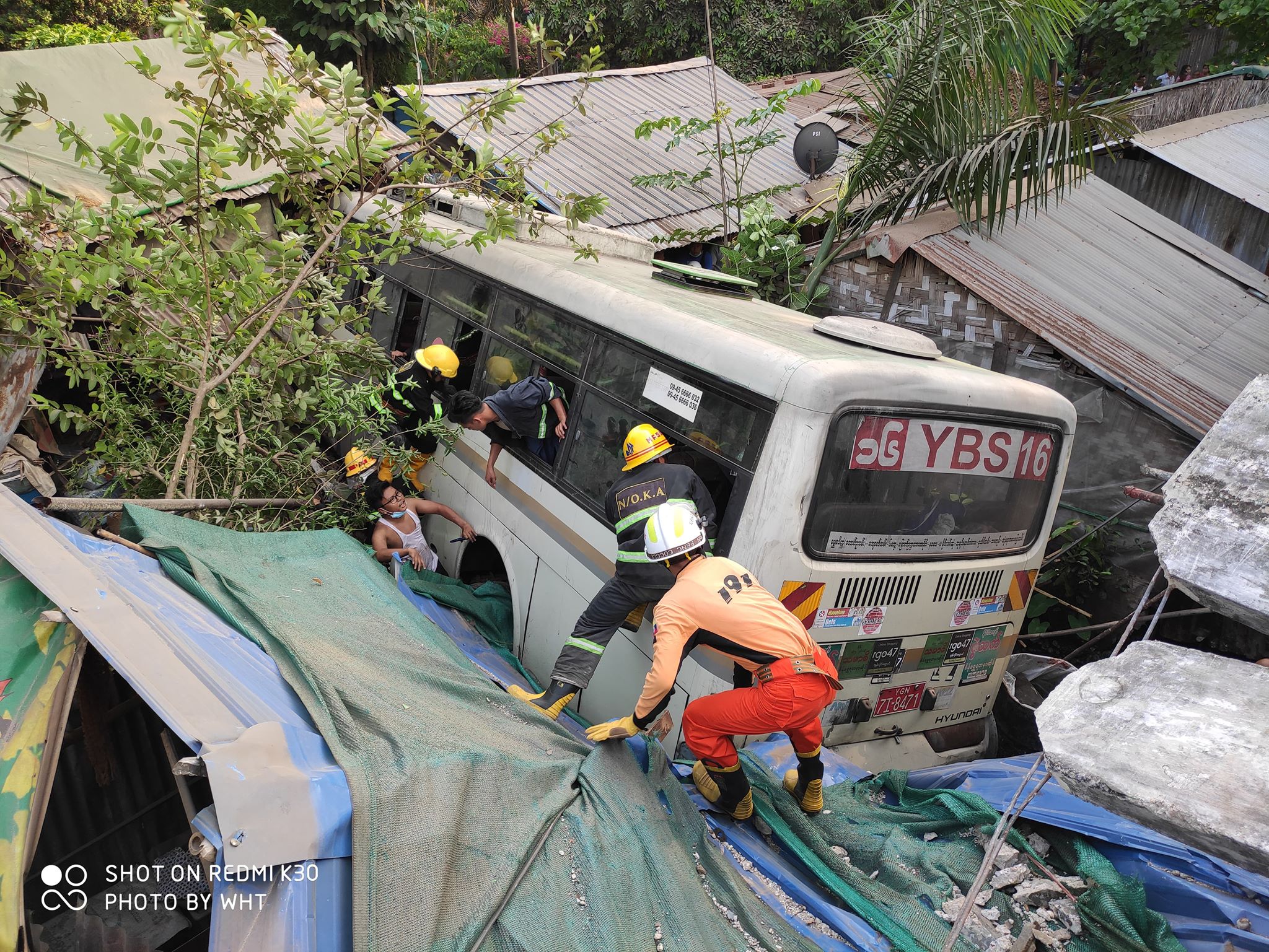 Myanmar Fire Services Department posted this photo on Facebook of the Yangon Bus Service vehicle lodged into the homes.