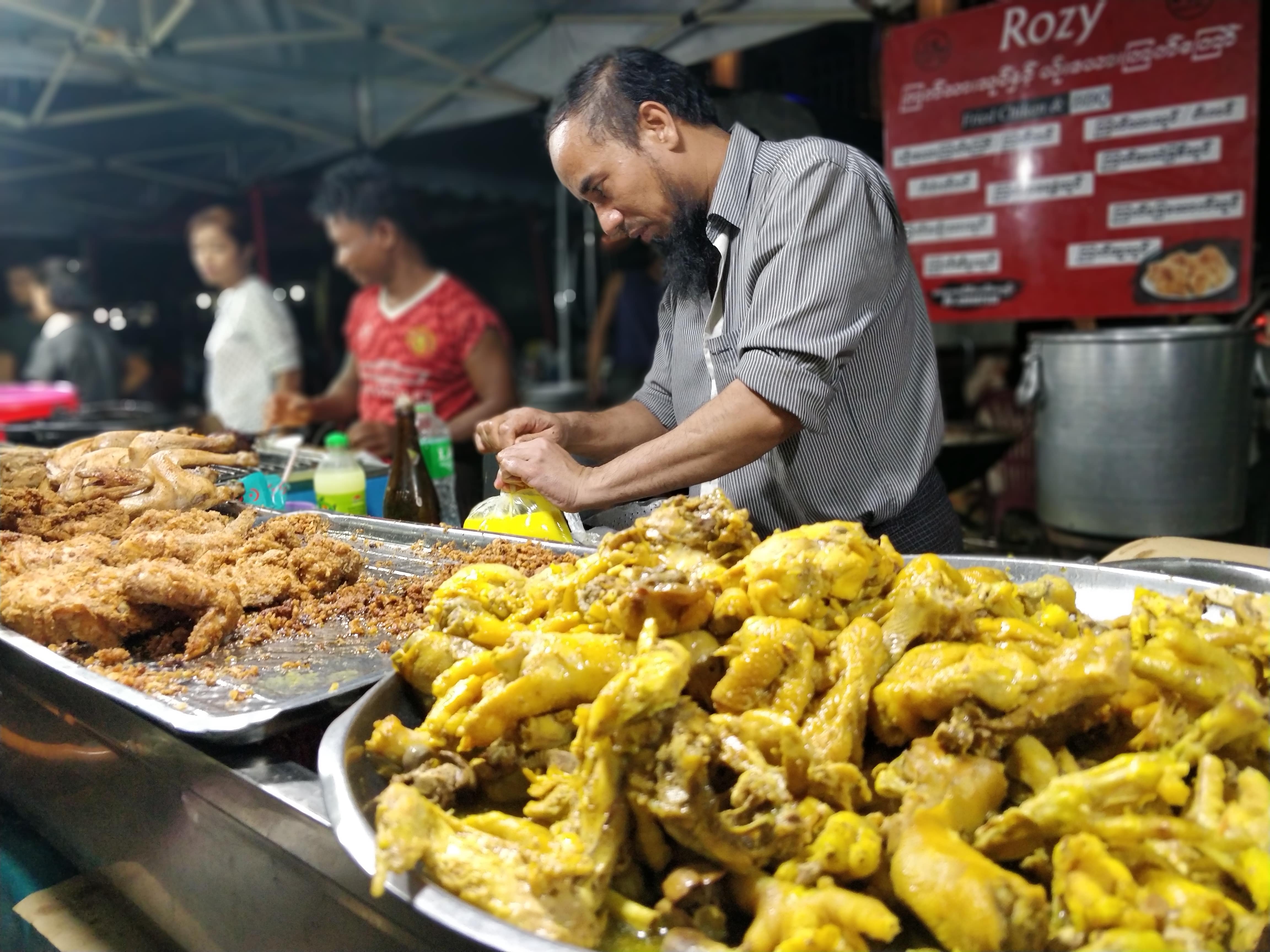 Hashim Bai serves customers at the popular street food stall in downtown Yangon. (Myanmar Mix)