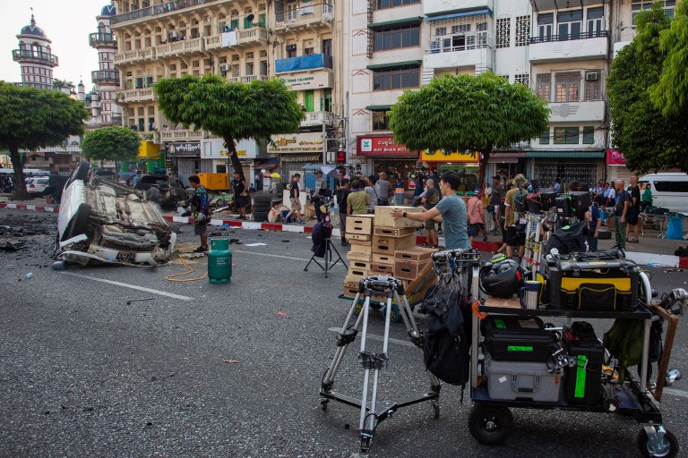 A production crew setting up a street scene during the filming of the movie Line Walker 2 near a pagoda in Yangon. (Sai Aung / AFP)