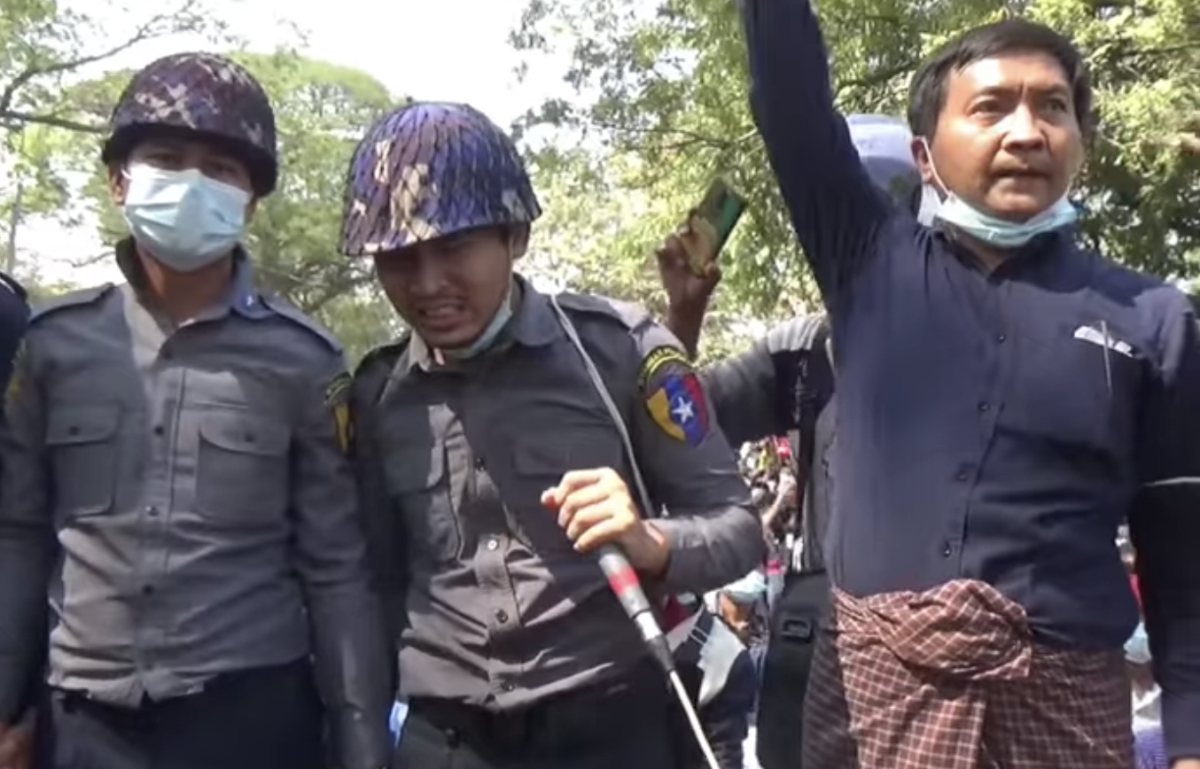 A police officer who joined protesters in Magway town speaks to the rally. The town saw the dramatic moment three police officers turned to face the water cannon in order to shield protesters from the blast on February 9. (Screenshot)