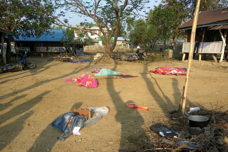 Bodies of policemen, killed in a militant attack, are covered at the Yoetayoke police station, near Sittwe in Rakhine State on March 10, 2019. (STR / AFP)