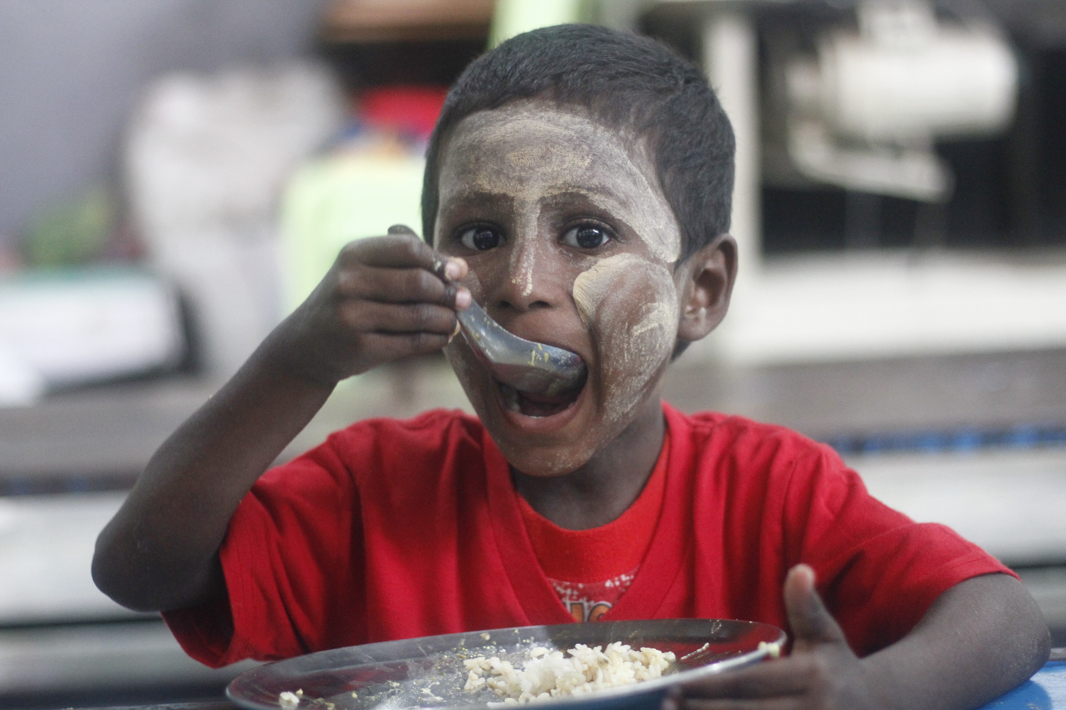 A boy eats lunch at a SONNE Social Organisation centre in Yangon. (Myanmar Mix)