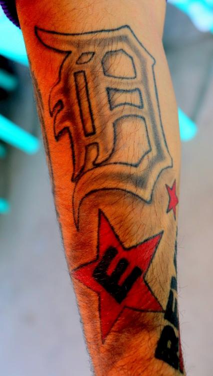 Stan's tattoos include the logo of Eminem's hip hop group D12 and a black 'E' in a red star.