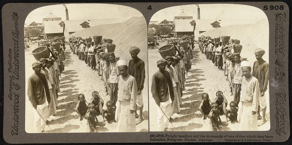 Freight handlers and the thousands of tons of rice which they have unloaded in Rangoon.