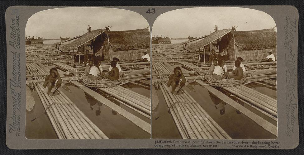Timber raft coming down the Irrawaddy River - the floating home of a group of natives.