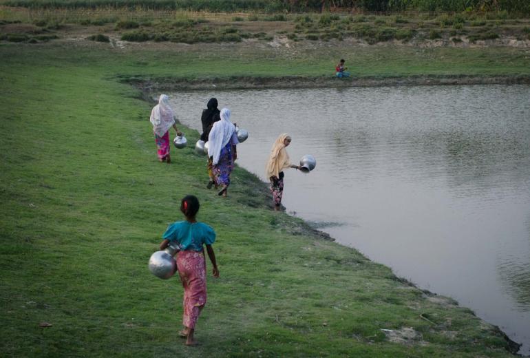 This photograph taken on March 10, 2018, Rohingya women collects water from a pond at Shan Taung village in the outskirt of Mrauk U township located in Rakhine state close to Bangladesh border. (Phyo Hein Kyaw / AFP)