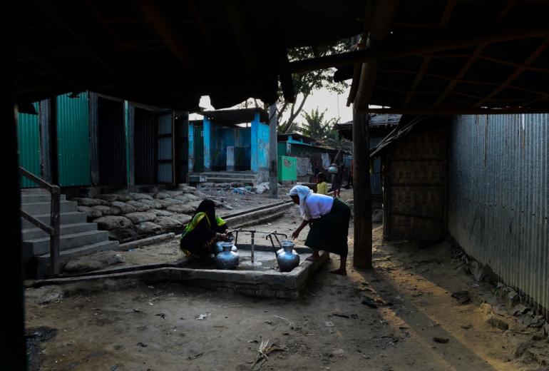 Rohingya refugee woman collect water from a tube well at Nayapara Rohingya refugee camp in Bangladesh's Teknaf district on April 6, 2018. (Munir Uz Zaman / AFP)