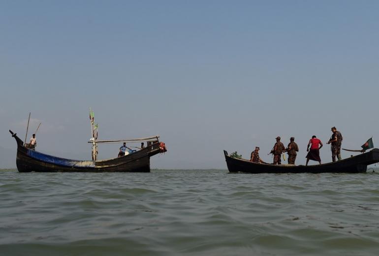 This photograph taken on April 6, 2018 shows Bangladesh Border Guard (BGB) personnel searching a fishing boat during their patrol along the Naf River in Teknaf, along the border between Myanmar and Bangladesh. (Munir Uz Zaman / AFP)