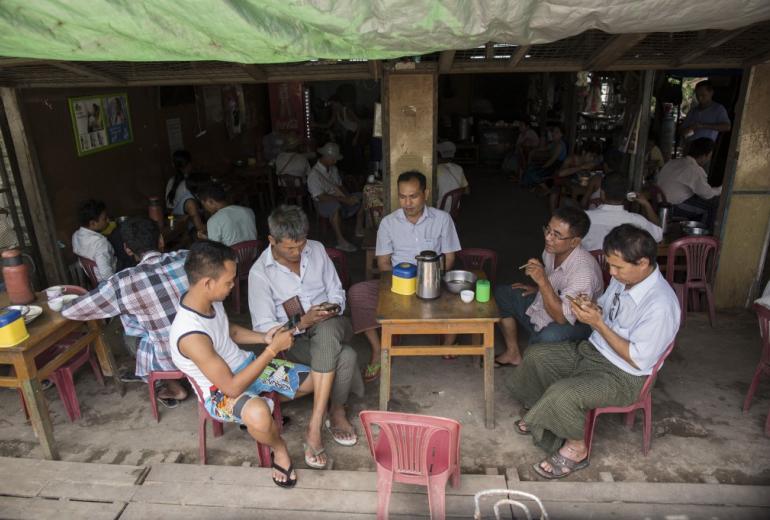 Men hangout to chat and browse Facebook at a Yangon teashop. (Sai Aung / AFP)