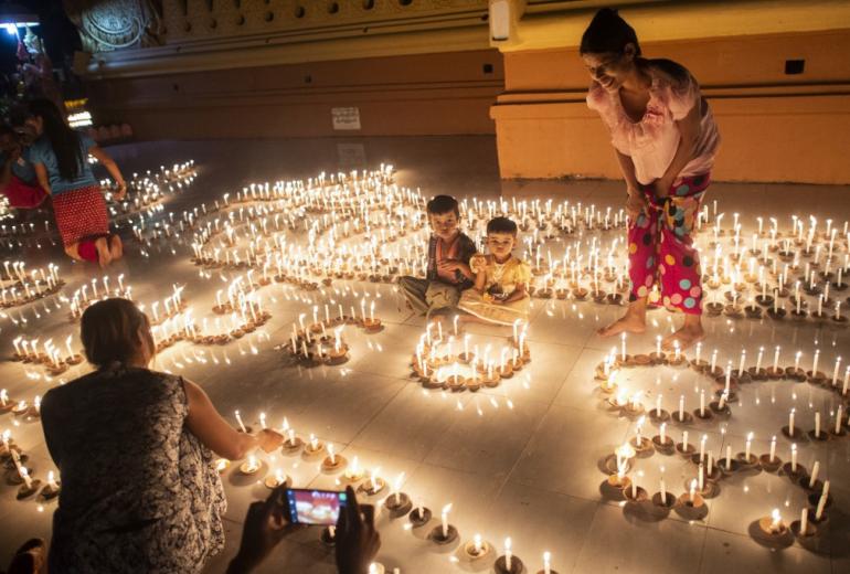 Buddhist devotees light candles at a pagoda during the Thadingyut festival in Bago last October. Thadingyut festival, the festival of Lights, is held during the full moon on the lunar month of Thadingyut and marks the end of the Buddhist Lent. (Ye Aung Thu / AFP)