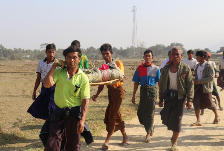 This photo taken on February 21, 2019 shows residents carrying a body of an ethnic Rakhine woman for burial in Rathedaung township after fresh fighting in Rakhine state between the Myanmar military and the Arakan Army, an ethnic Rakhine force. (AFP)