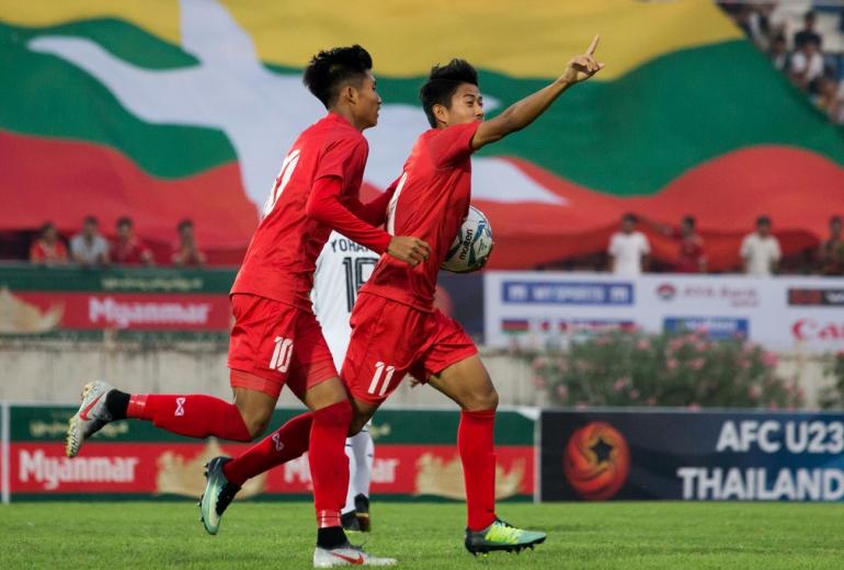 Myanmar's Hein Htet Aung (R) celebrates scoring during the Tokyo 2020 Olympic Games men's Asian qualifier football match between Myanmar and East Timor in Yangon on March 22, 2019.  (Sai Aung Main / AFP)
