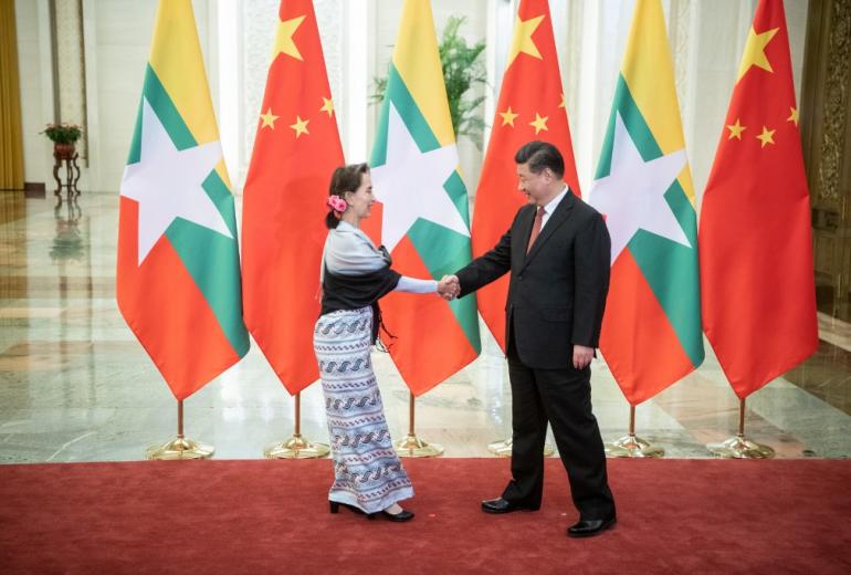 Chinese President Xi Jinping (R) shakes hands with Myanmar State Counsellor Aung San Suu Kyi at the Great Hall of the People in Beijing on April 24, 2019. (Fred Dufour / Pool / AFP)