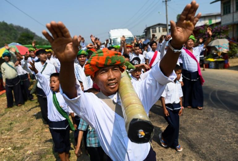 Pa'O ethnic people dance as they bring a homemade rocket to launch during a festival in Nantar, Shan state. (Ye Aung Thu / AFP)