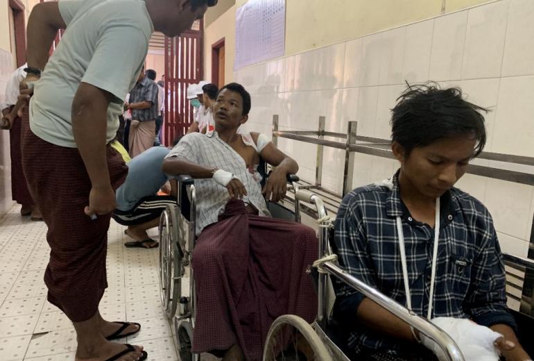 Injured people from Kyauk Tan village in Rathedaung township wait in a hospital in Rakhine state's capital Sittwe in western Myanmar on May 2, 2019, after the army opened fire on a group of ethnic Rakhine detainees at a school in the village. (STR / AFP)