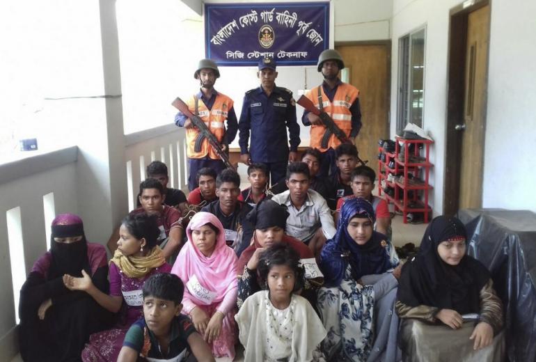  Bangladesh Coast Guard pose for a photo with rescued Rohingya refugees in Teknaf on May 18, 2019. (STR / AFP)